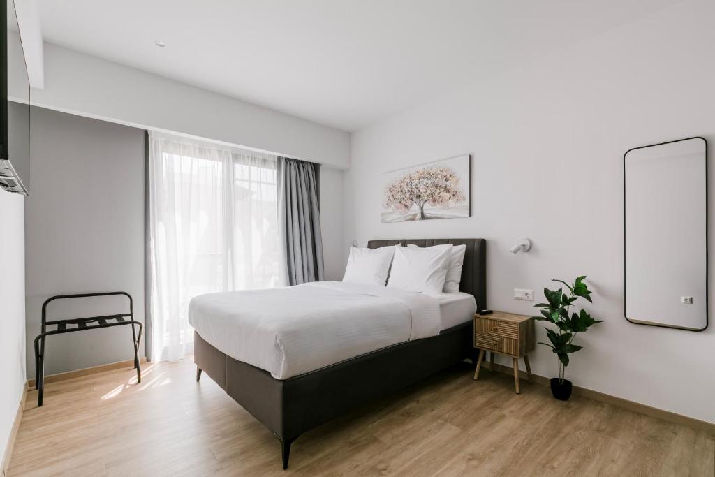 a bedroom with a large bed and a window at B48 Athens Dafni in Athens