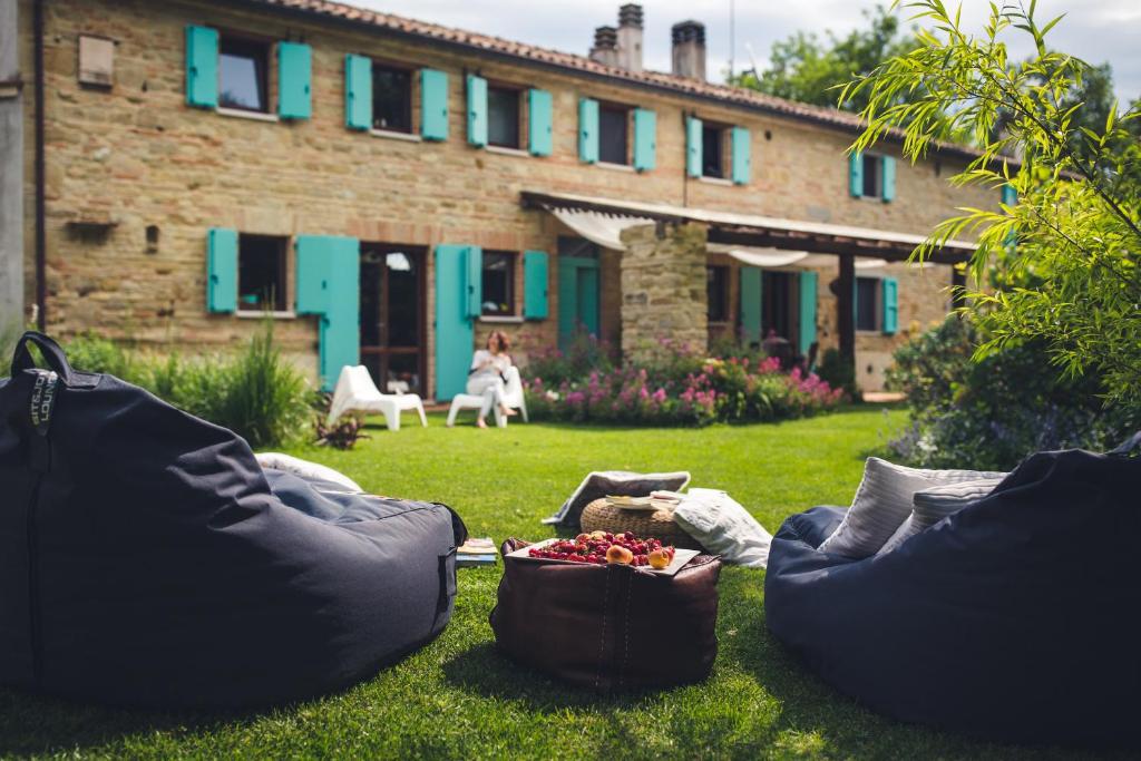 two chairs sitting in the grass with a bowl of fruit at PranaVita, B&B Naturale in Pesaro