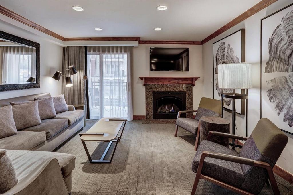 a living room with a couch and a fireplace at Luxury 1 Bedroom At The Hythe In Lionshead Village in Vail