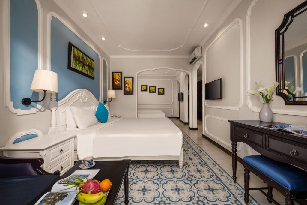 Giường trong phòng chung tại Hoi An Rosemary Boutique Hotel & Spa - A Peaceful Retreat