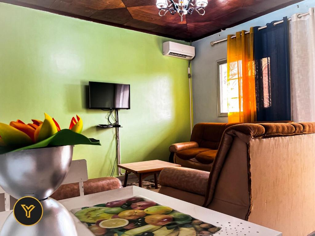 salon ze stołem i talerzem jedzenia w obiekcie Appartement Bruno, 2 Chambres w mieście Jaunde