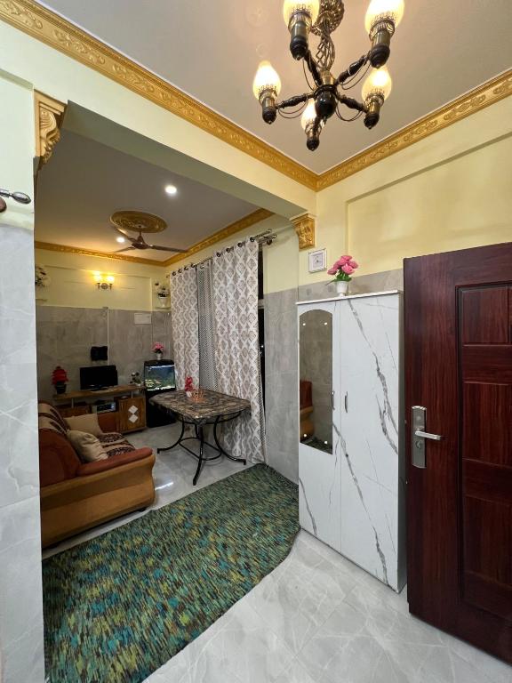 a living room with a door and a couch at Cozy Prime Private Service Apartment in Bangalore in Bengaluru