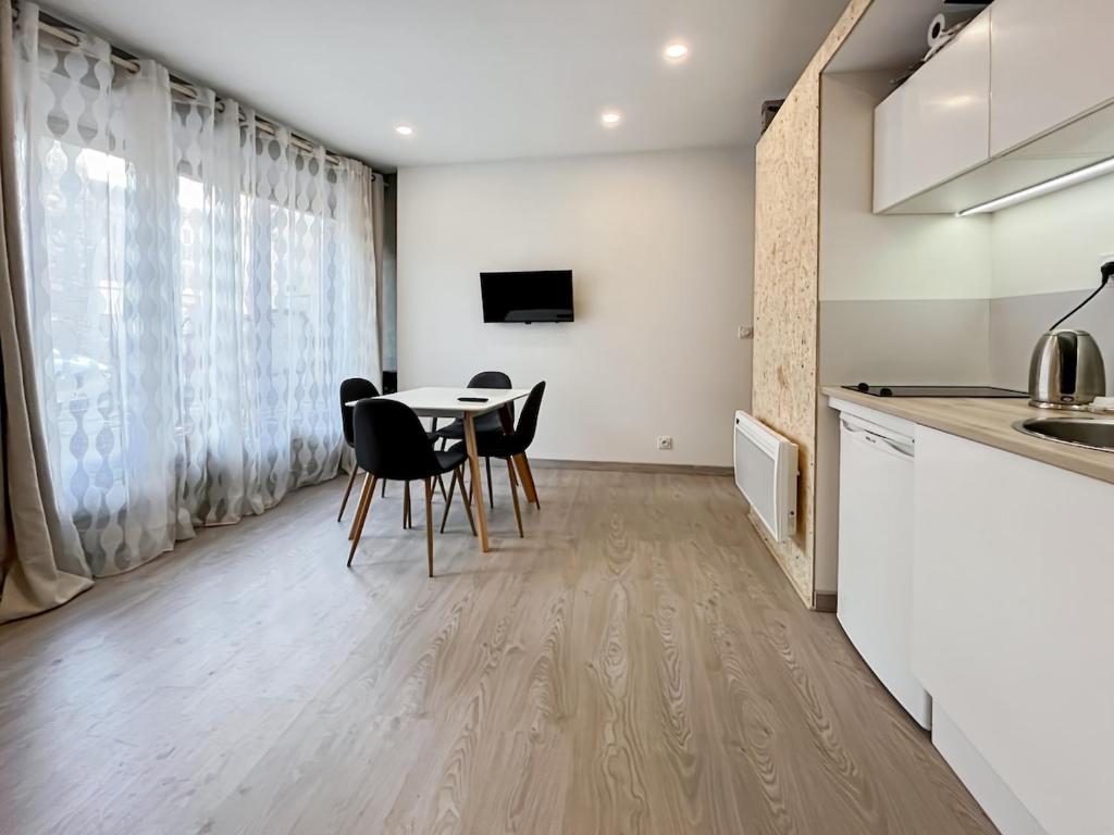 a kitchen and dining room with a table and chairs at Maison FLOËGE 4 personnes in Burzet