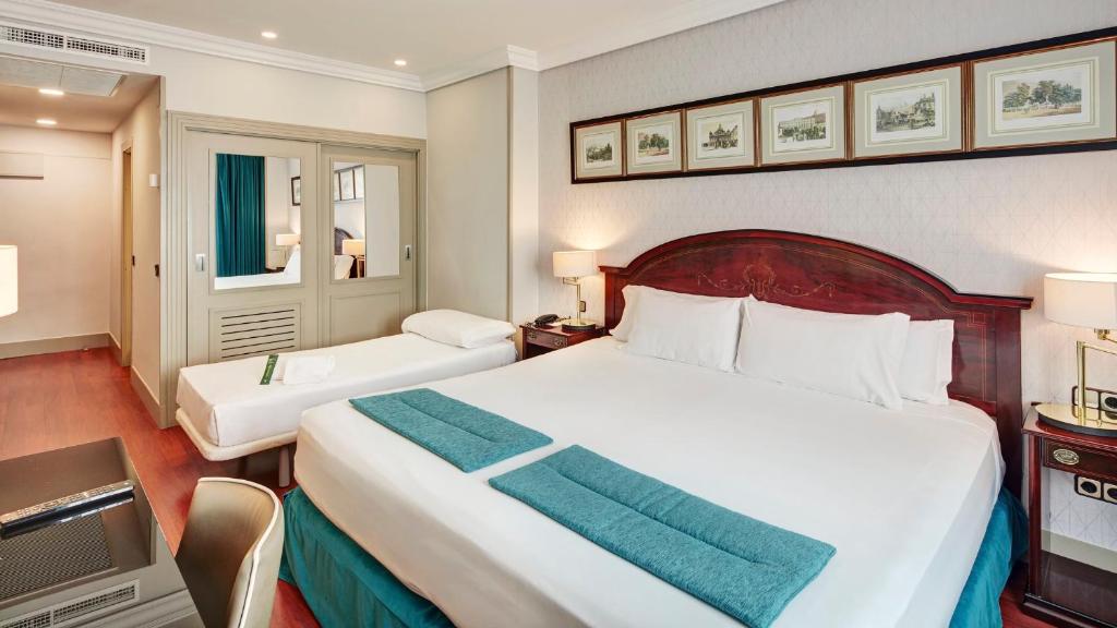 A bed or beds in a room at Sercotel Gran Hotel Conde Duque