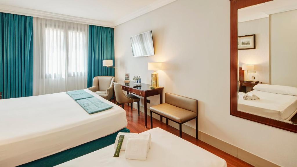 A bed or beds in a room at Sercotel Gran Hotel Conde Duque