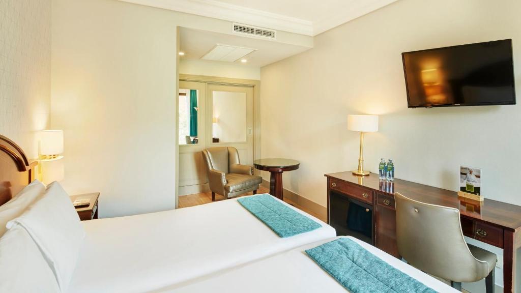 A bed or beds in a room at Sercotel Gran Hotel Conde Duque