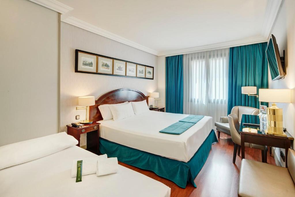 A bed or beds in a room at Sercotel Gran Hotel Conde Duque