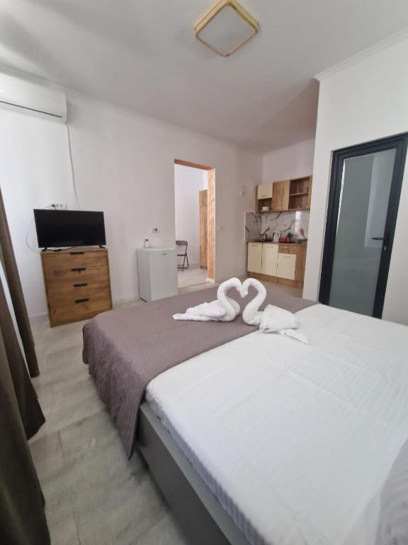 a bedroom with a large bed with a towel on it at Casa Carina in Brăila