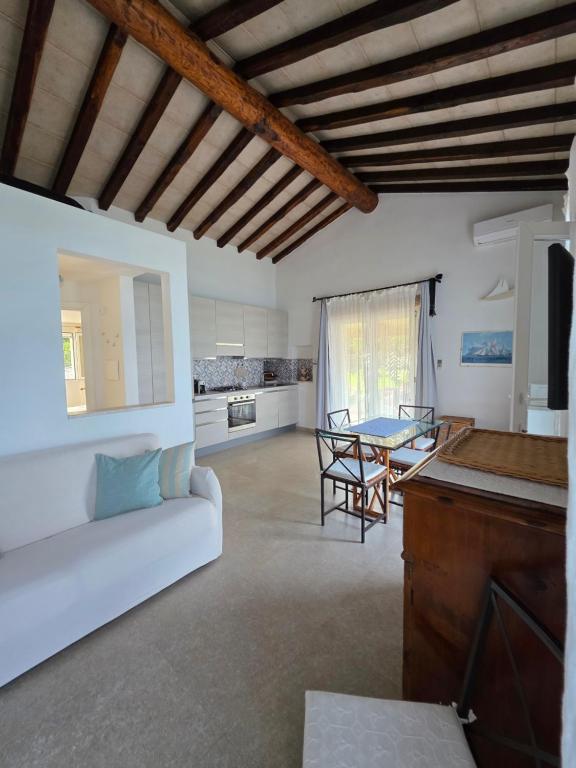 a living room with a white couch and a table at Blue Eden La Maddalena in La Maddalena