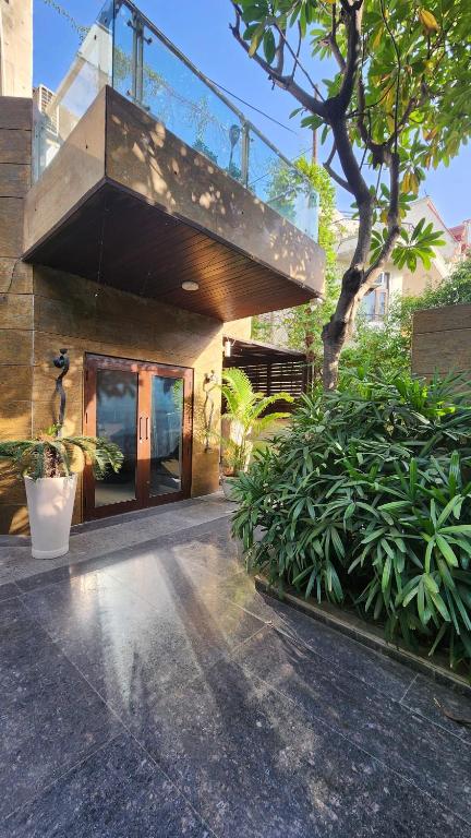 a building with a balcony on top of it at Nivasa Villa - 5 BHK Triplex House Near Cyberhub in Gurgaon