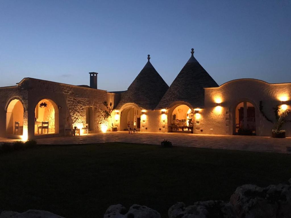 an exterior view of a building at night at Masseria Camarda in Ceglie Messapica