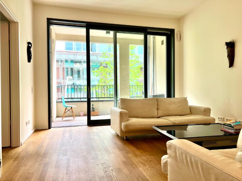 a living room with a couch and a table at Berlin -Central-Mitte Light Filled 2BD in Niederdorla