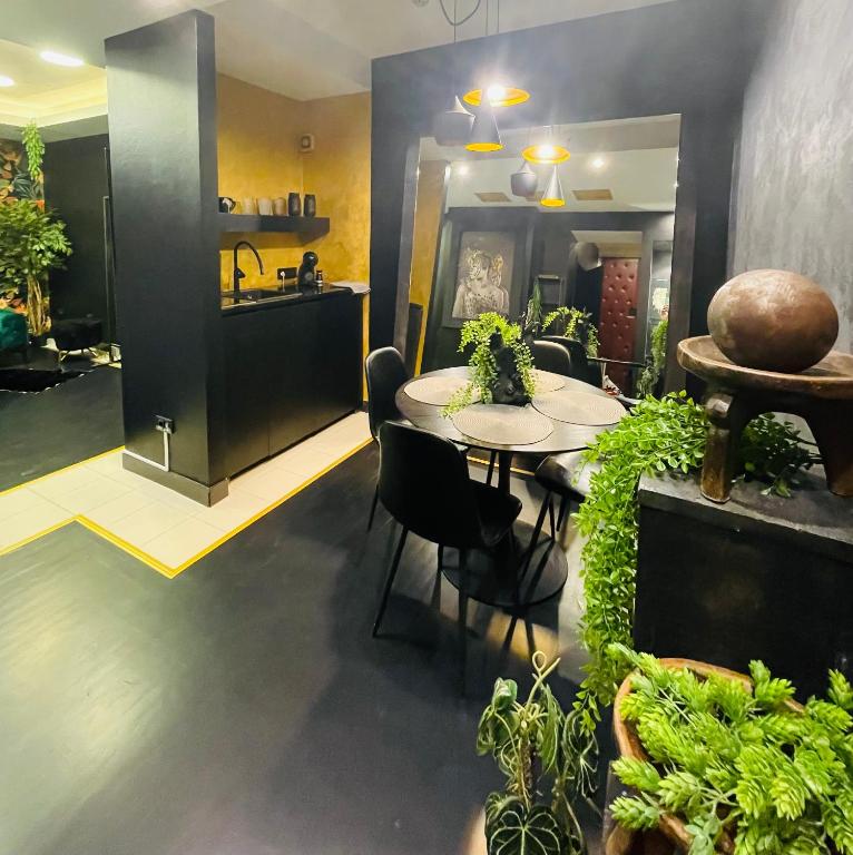 a dining room with a table and some plants at Knez in Belgrade