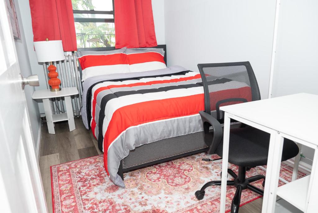a bedroom with a red and white bed and a desk at Ruby2 Room at Brighton Beach 2Min Walk to Ocean & Subway Chic Stay in Brooklyn