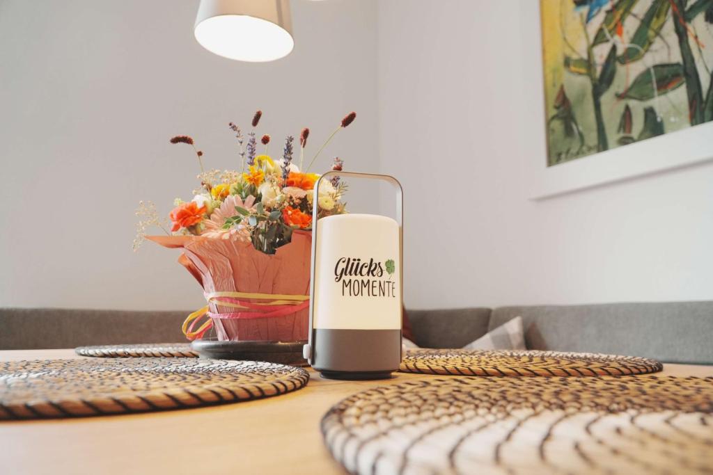 a candle sitting on top of a table with a vase at Ferienhaus Ahorn in Neustift im Stubaital