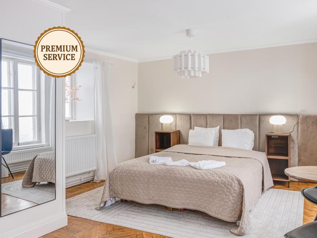 a bedroom with a bed and a sign that reads premium service at Apartment in Old Town in Stockholm