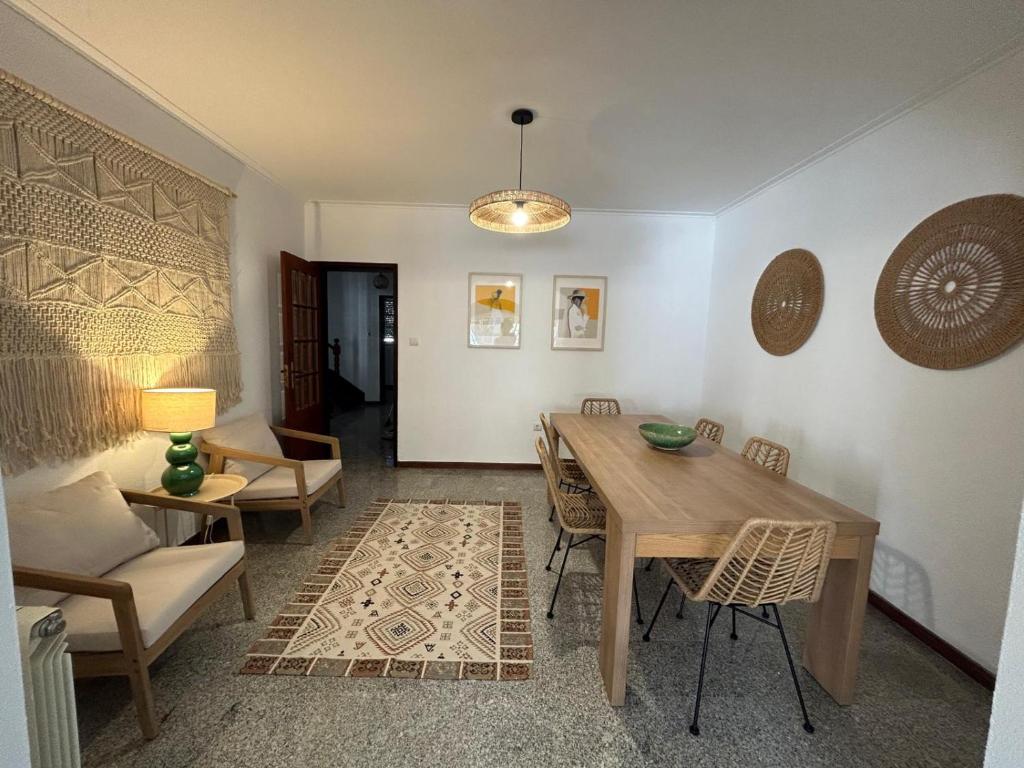 a living room with a wooden table and chairs at Casa Na Vila in Vila Pouca de Aguiar