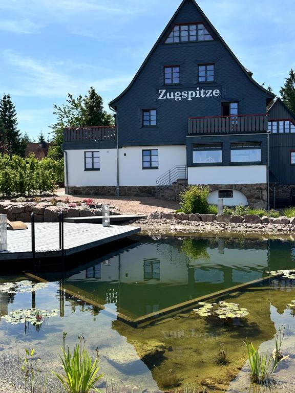a large black building with a marina at Zugspitze Apartment GLÜCK.AUF in Waldidylle