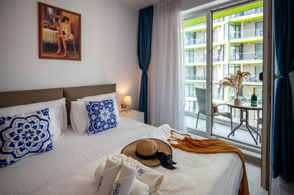 una camera d'albergo con un letto con un cappello sopra di Mediteraneo Apartment Alezzi Beach Spa&Pool Resort a Mamaia