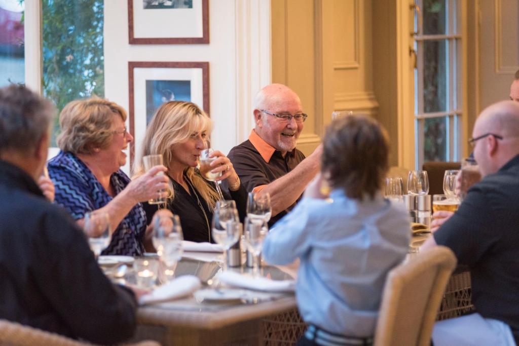 a group of people sitting around a table at The Royal Hotel in Ventnor