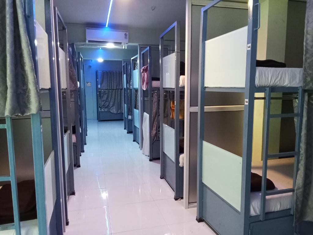 a corridor of a prison cell with bunk beds at Patel inn dormitory in Mumbai