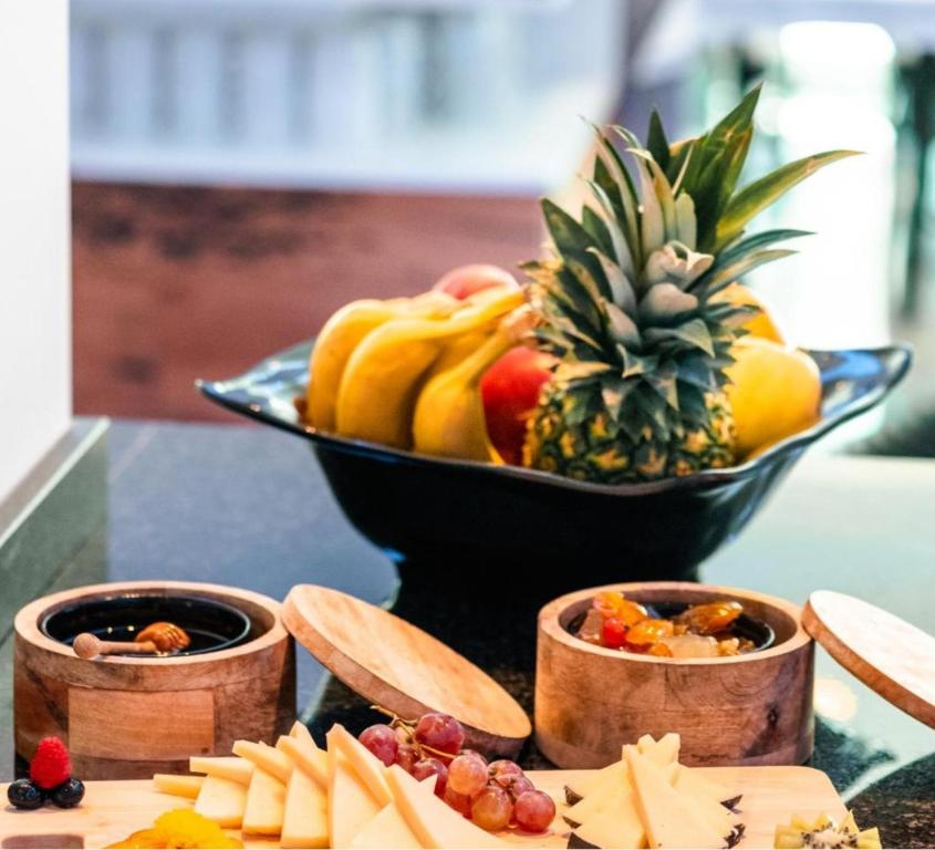 a bowl of fruit on a table with a bowl of pineapple at La Corte dei Fiori in Albavilla