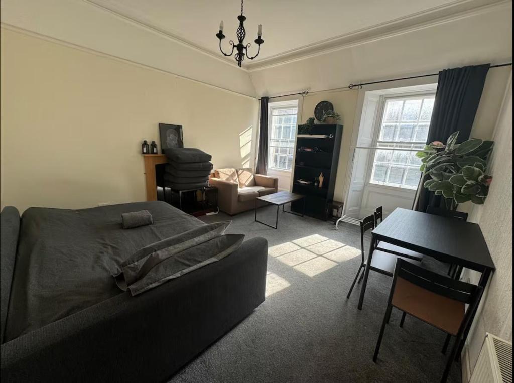 a living room with a couch and a table at Edinburgh Central Cozy Flat in Edinburgh