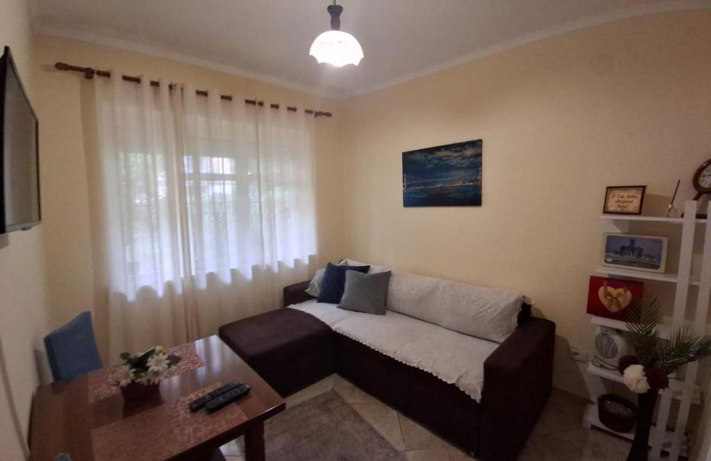 a living room with a couch and a table at Downtown Authentic Apartment Tirana Myslym Shyri in Tirana