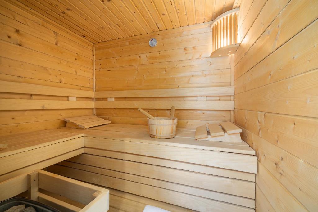 a wooden sauna with a bucket in it at The Butcher in Bruges