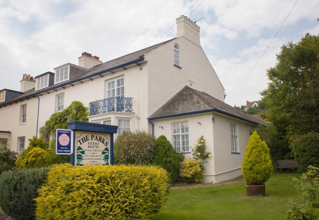 a white house with a sign in front of it at The Parks Guest House in Minehead