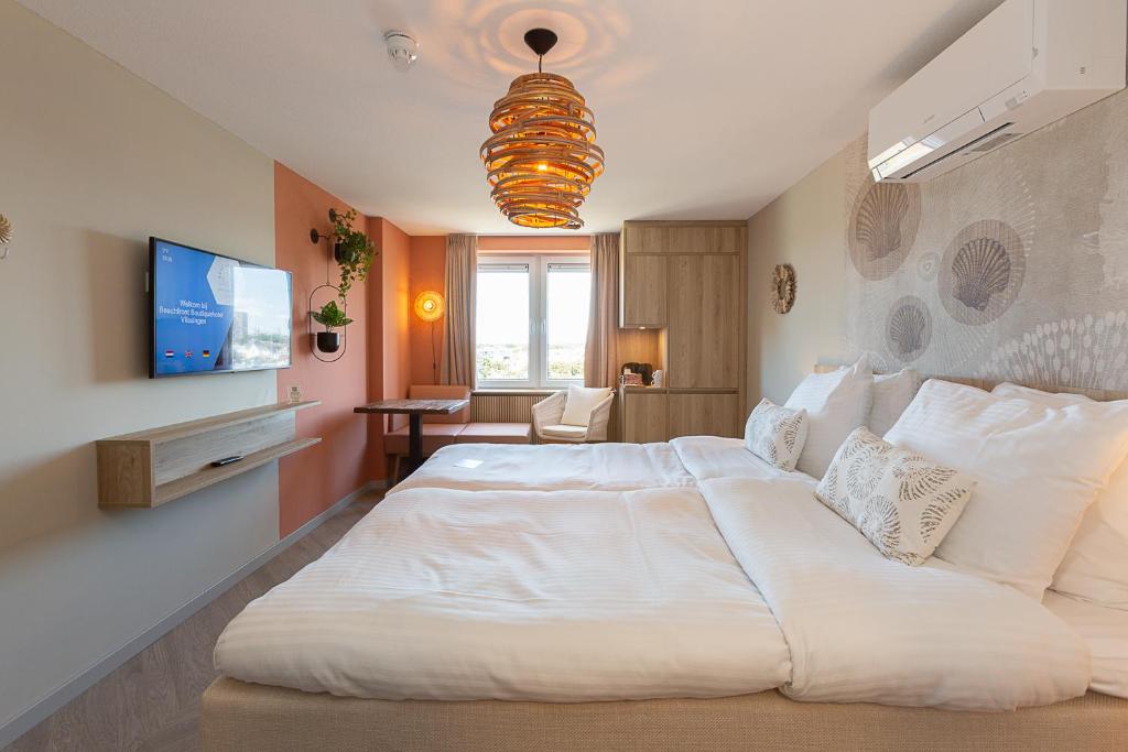 Postel nebo postele na pokoji v ubytování Beachfront Boutiquehotel