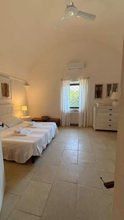 A bed or beds in a room at Masseria Frassaniti