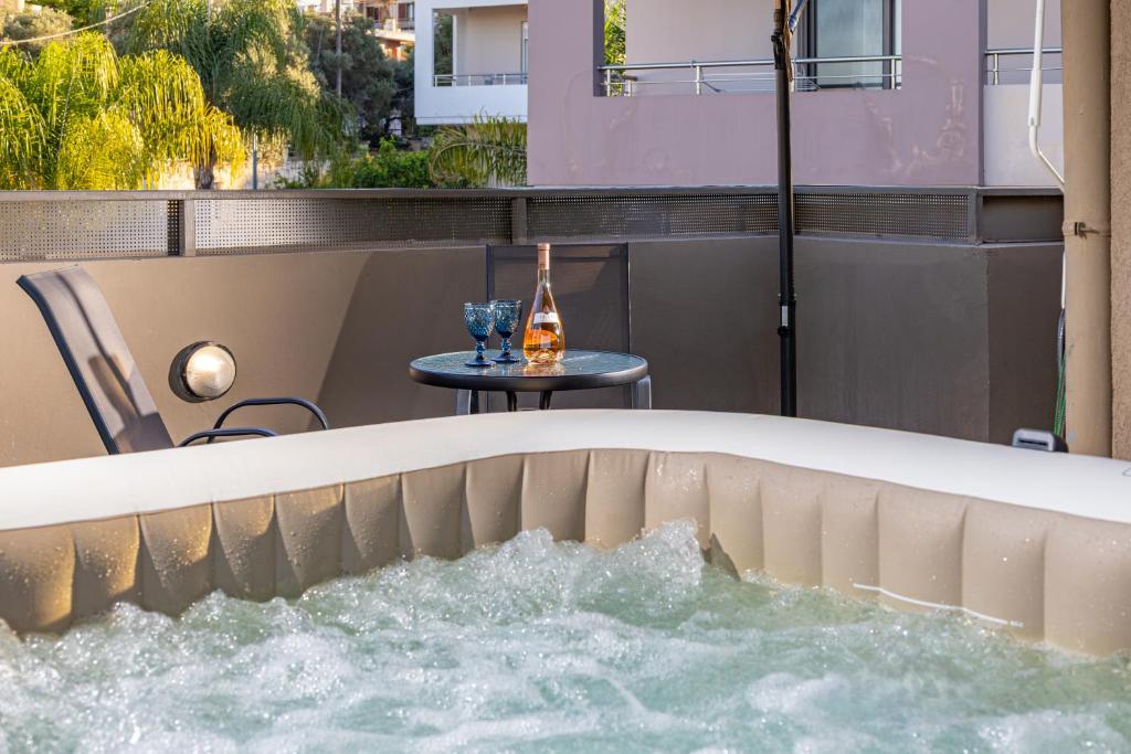 a bath tub with water in it with a table at Panorama View with Private Hot Tub by 8essentially in Daratso