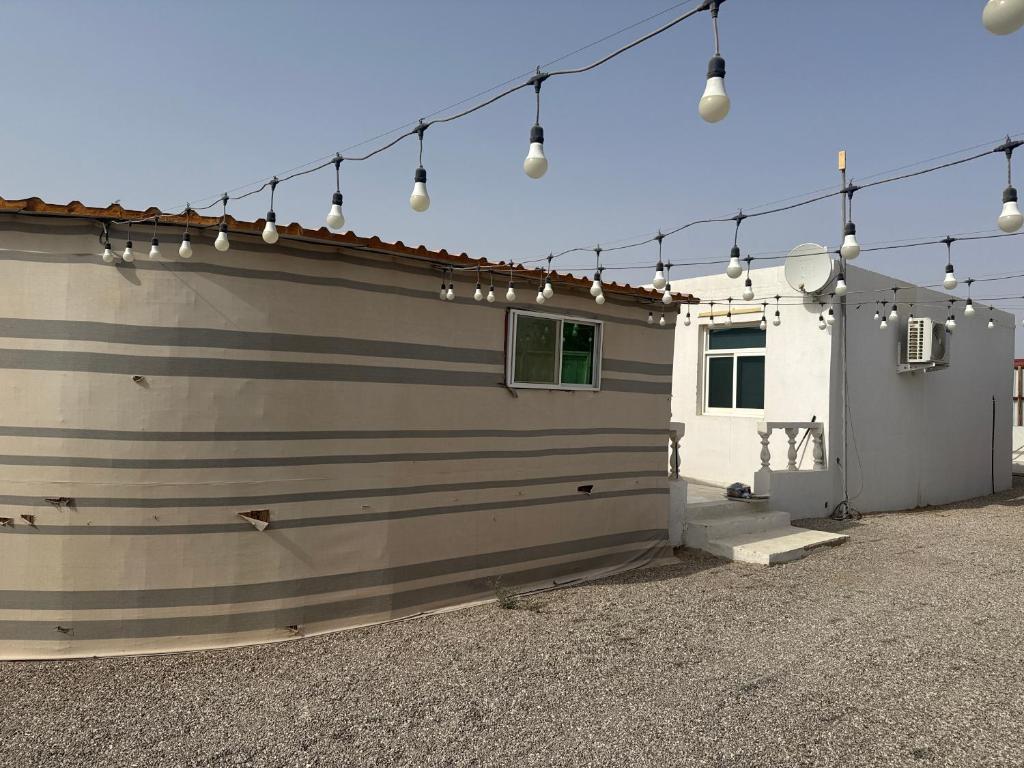 a garage with lights on the side of a house at Amg in Sabkhah