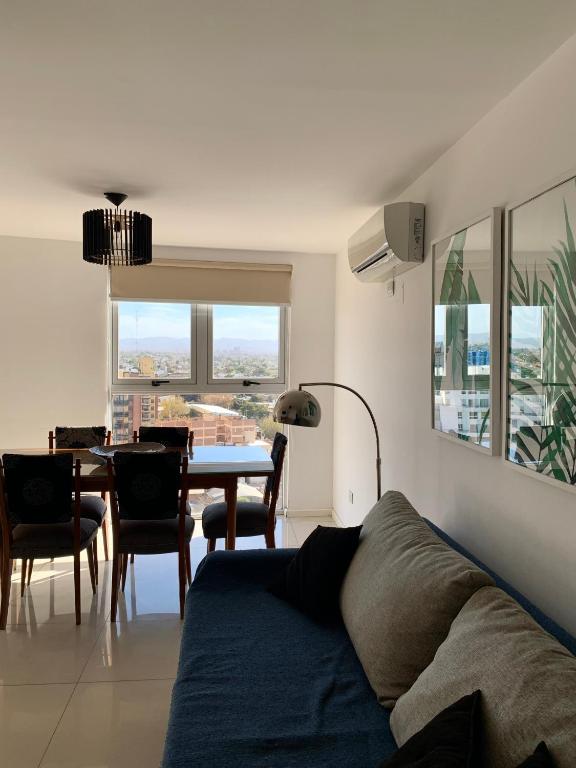 a living room with a couch and a table at ALOHA Güemes Premium, 2 dorm con Vista a las Sierras in Córdoba