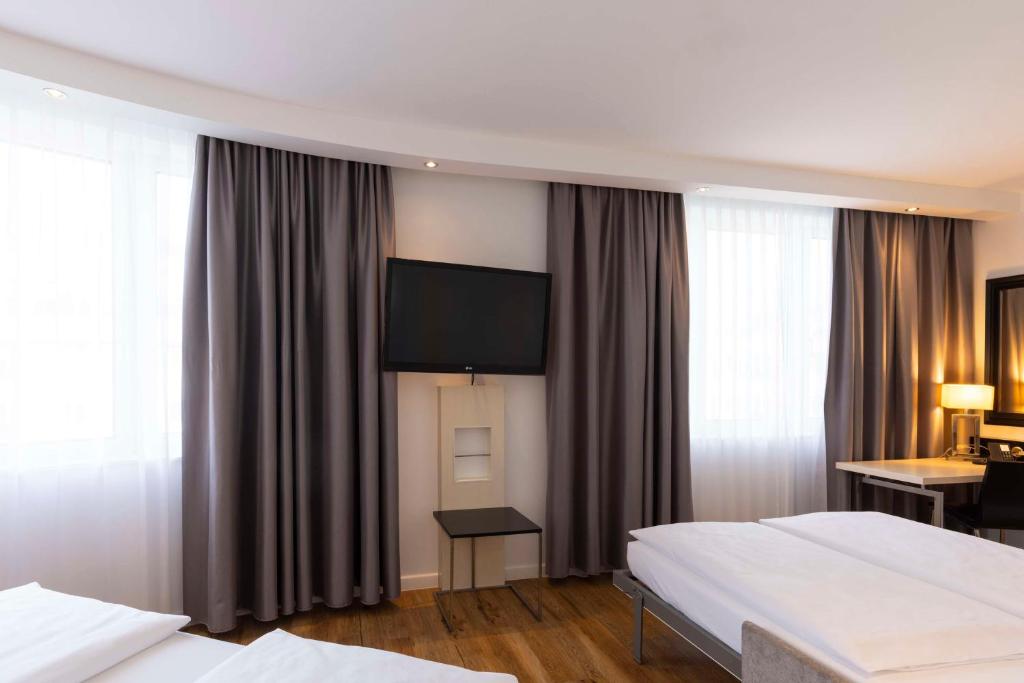 Postel nebo postele na pokoji v ubytování Scandic Berlin Kurfürstendamm