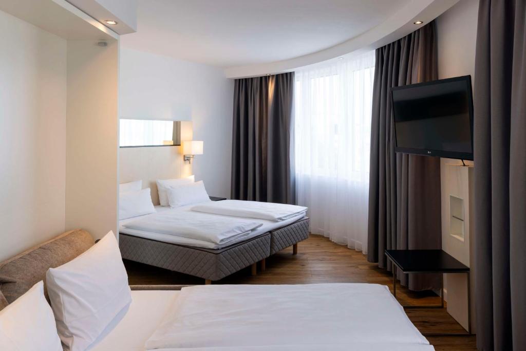 Postel nebo postele na pokoji v ubytování Scandic Berlin Kurfürstendamm