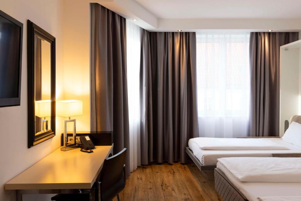 Postel nebo postele na pokoji v ubytování Scandic Berlin Kurfürstendamm