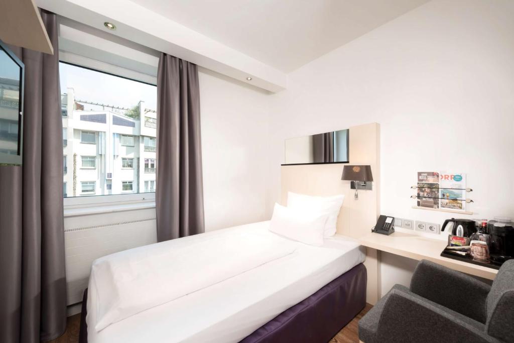 Postel nebo postele na pokoji v ubytování Scandic Berlin Kurfürstendamm