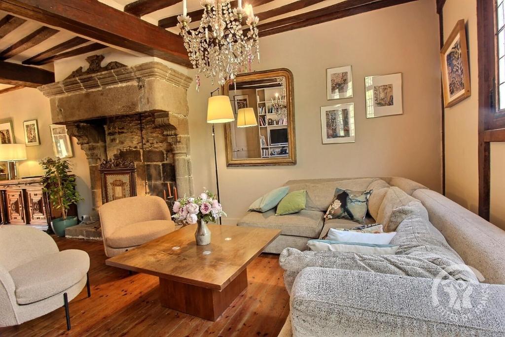 a living room with a couch and a table at Hôtel des ducs de bretagne pour 2 in Saint-Brieuc