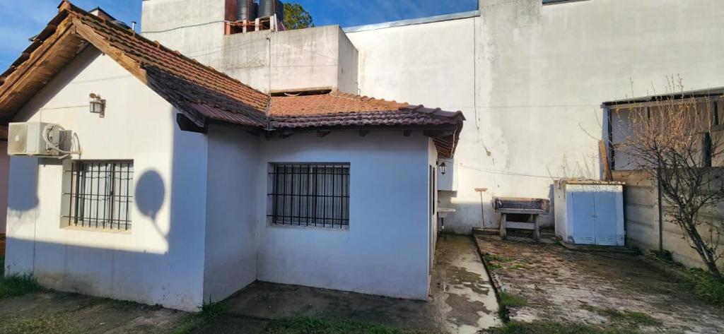a small white house with a red roof at Mi Casita in Colón