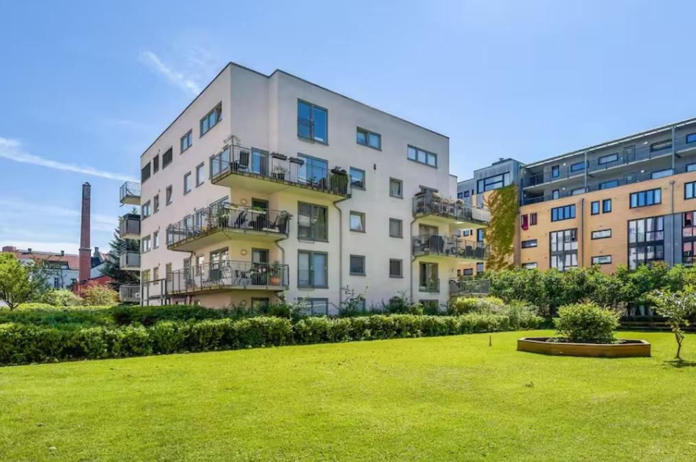 an apartment building with a lawn in front of it at Two bedroom apt near Oslo City Center, Norway in Oslo