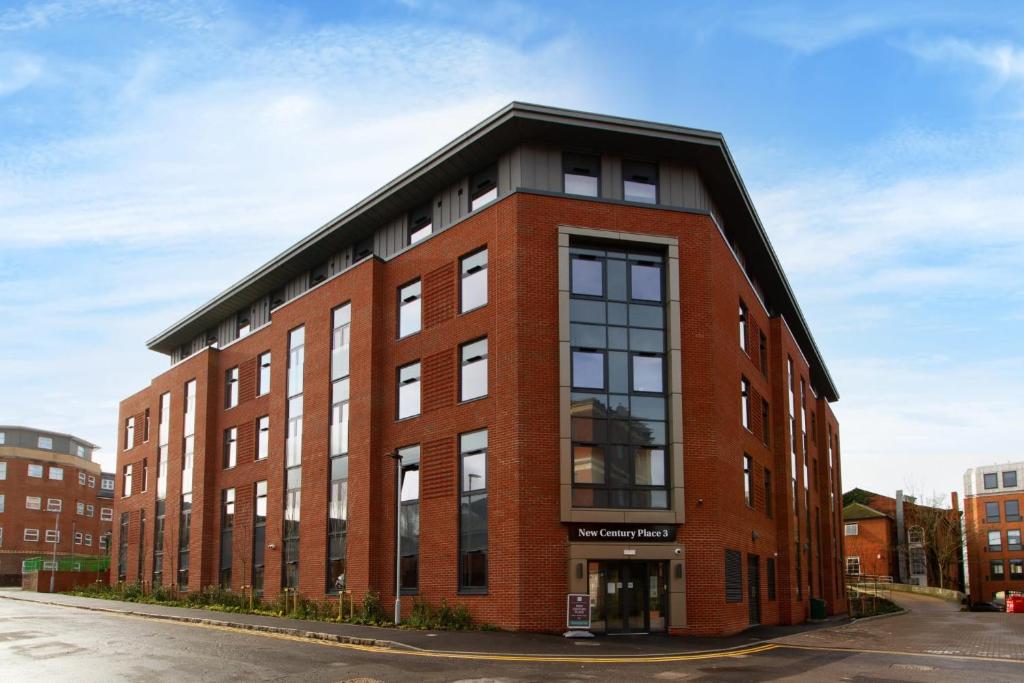a red brick building with a black roof at For Students Only - Studio Rooms in Reading in Reading