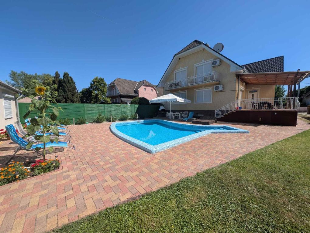 a backyard with a swimming pool and a house at Holiday home in Siofok - Balaton 19638 in Siófok