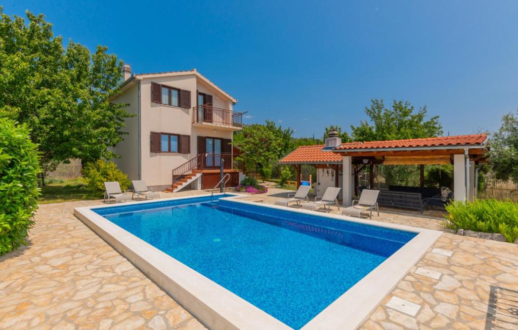 a villa with a swimming pool and a house at Villa Ivka-Omis by Villas Guide in Katuni