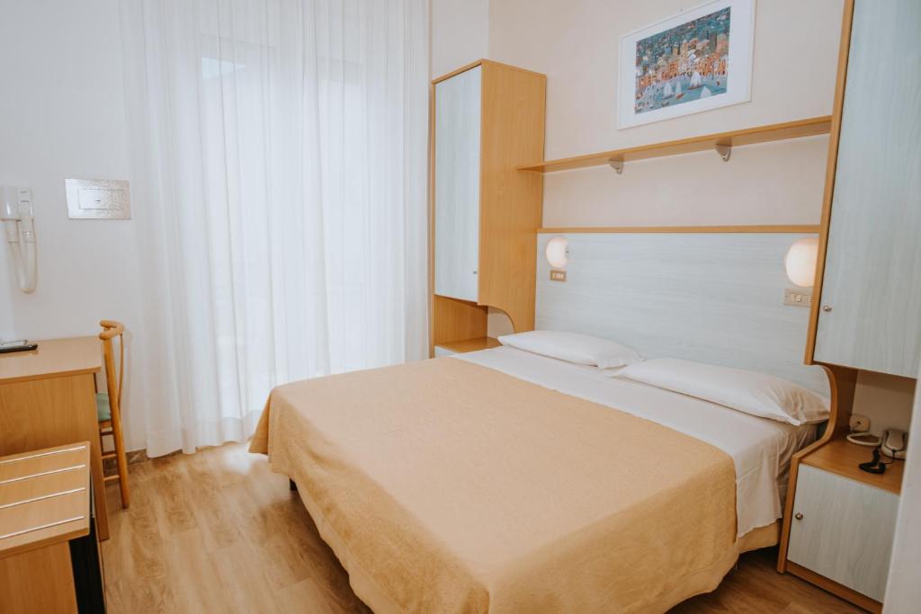 Postel nebo postele na pokoji v ubytování Hotel Gabriella