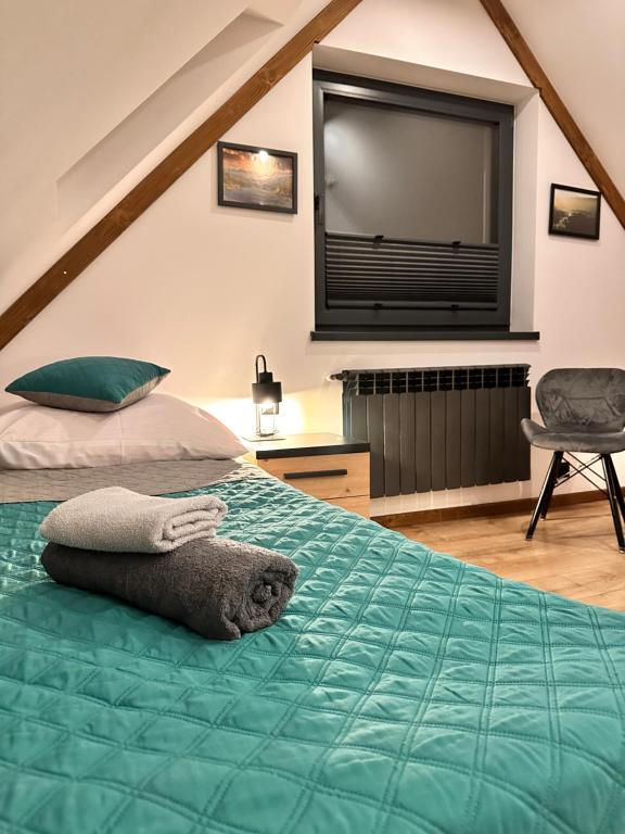 a bedroom with a bed with a flat screen tv at Twoje Miejsce in Czarna Góra