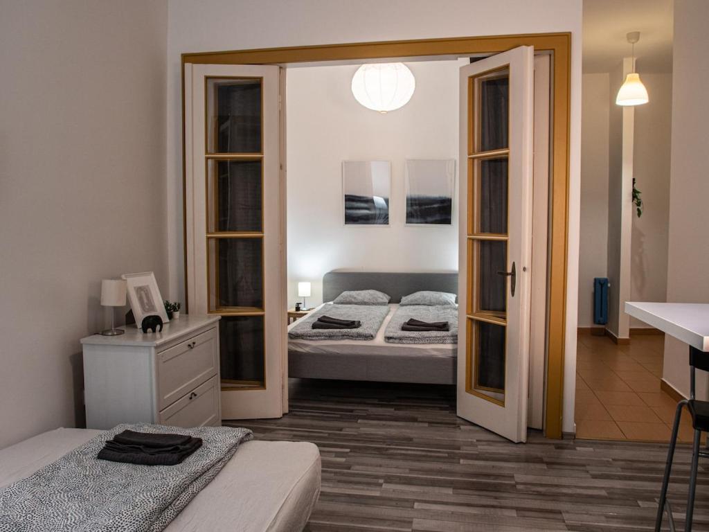 a bedroom with two beds and a mirror at Chic Asboth City Center Loft - Perfect Location in Budapest