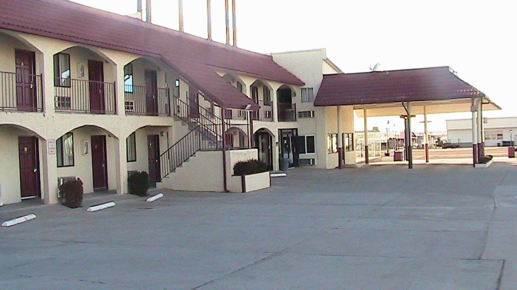 an empty parking lot in front of a building at Travelodge by Wyndham Holbrook in Holbrook