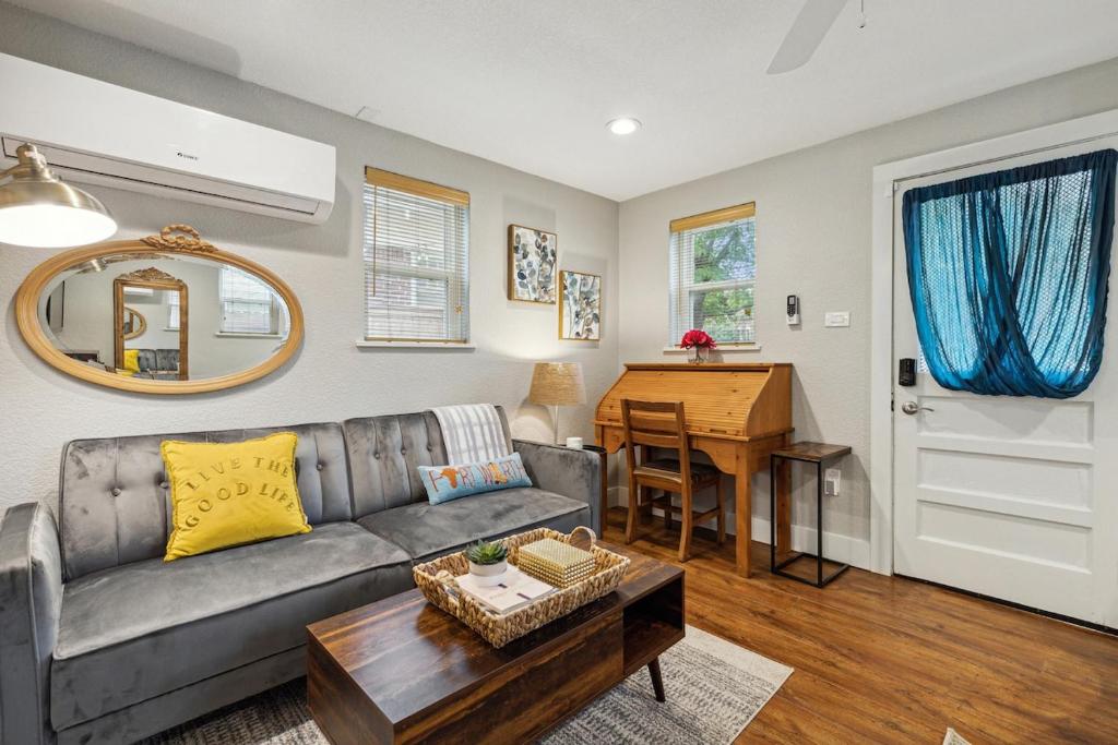 a living room with a couch and a table at The Cultural District Cottage in Fort Worth